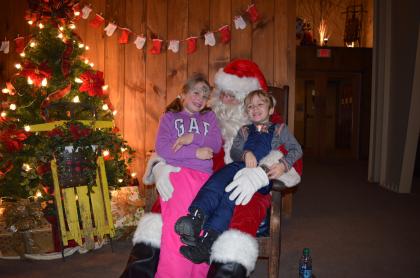 Kids sitting with Santa.