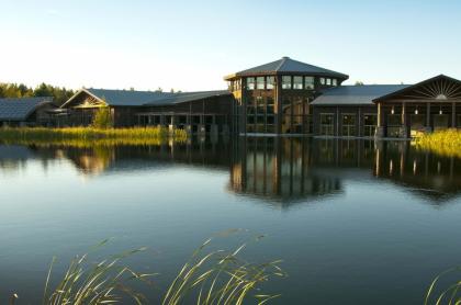 View of The Wild Center sitting across a shimmering body of water