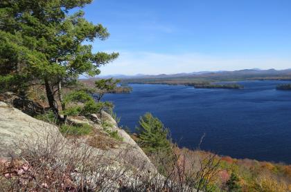 A summer view of Lake Lila from a rocky outcrop with pines.