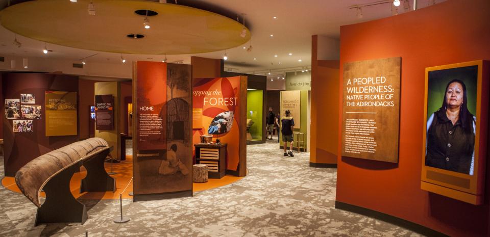 A brightly colored indoor museum exhibit highlights Indigenous art and culture.