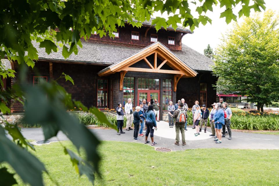 a crowd gathers around the Adirondack Experience building.