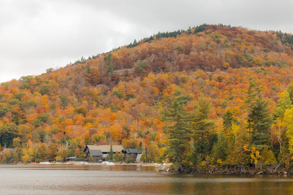 A lakeside view of Blue Mountain Lake during fall.