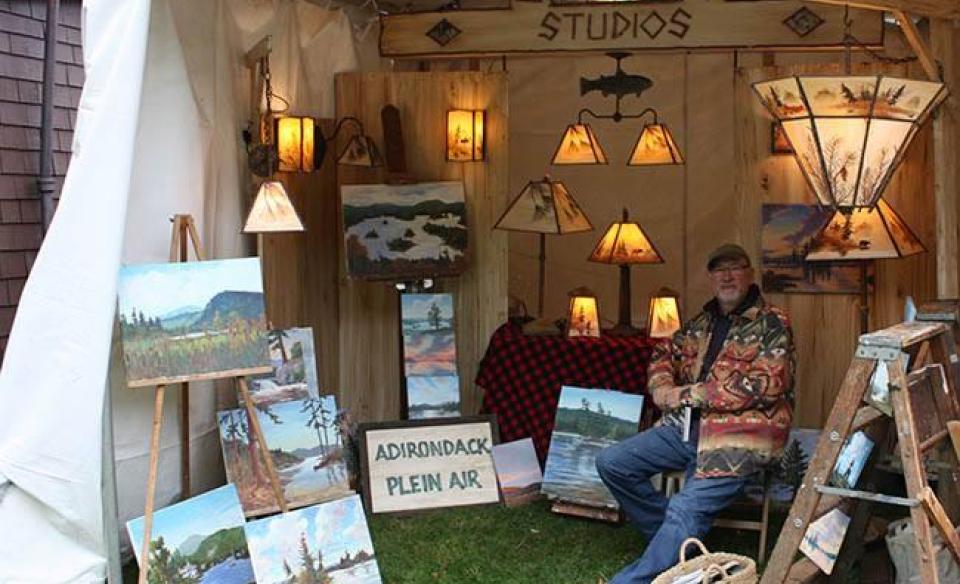 A booth selling art and lamps