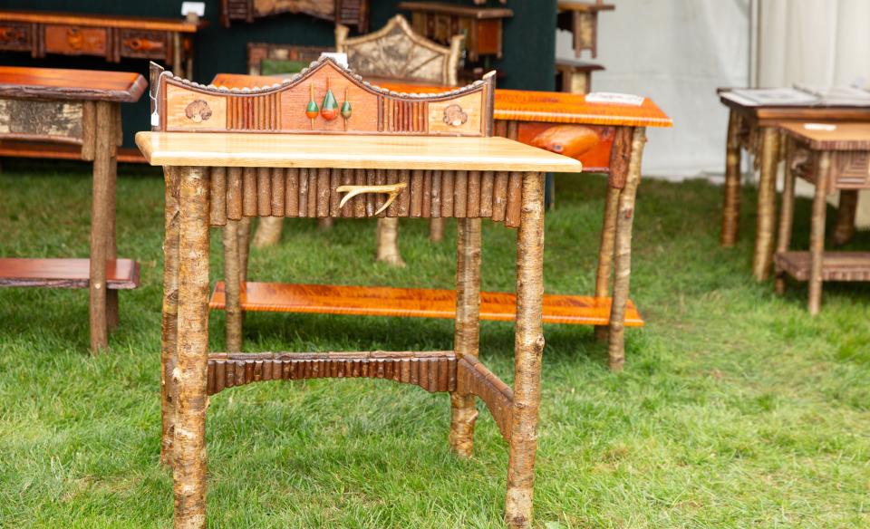 Several different end tables made from wood, twigs, branches and other rustic materials