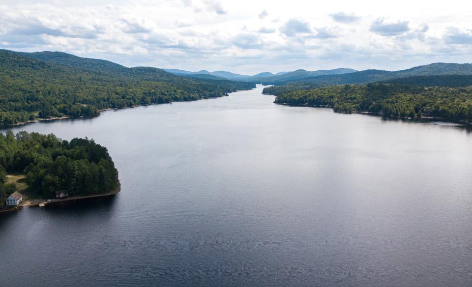 A wide part of a long lake surrounded by mountains